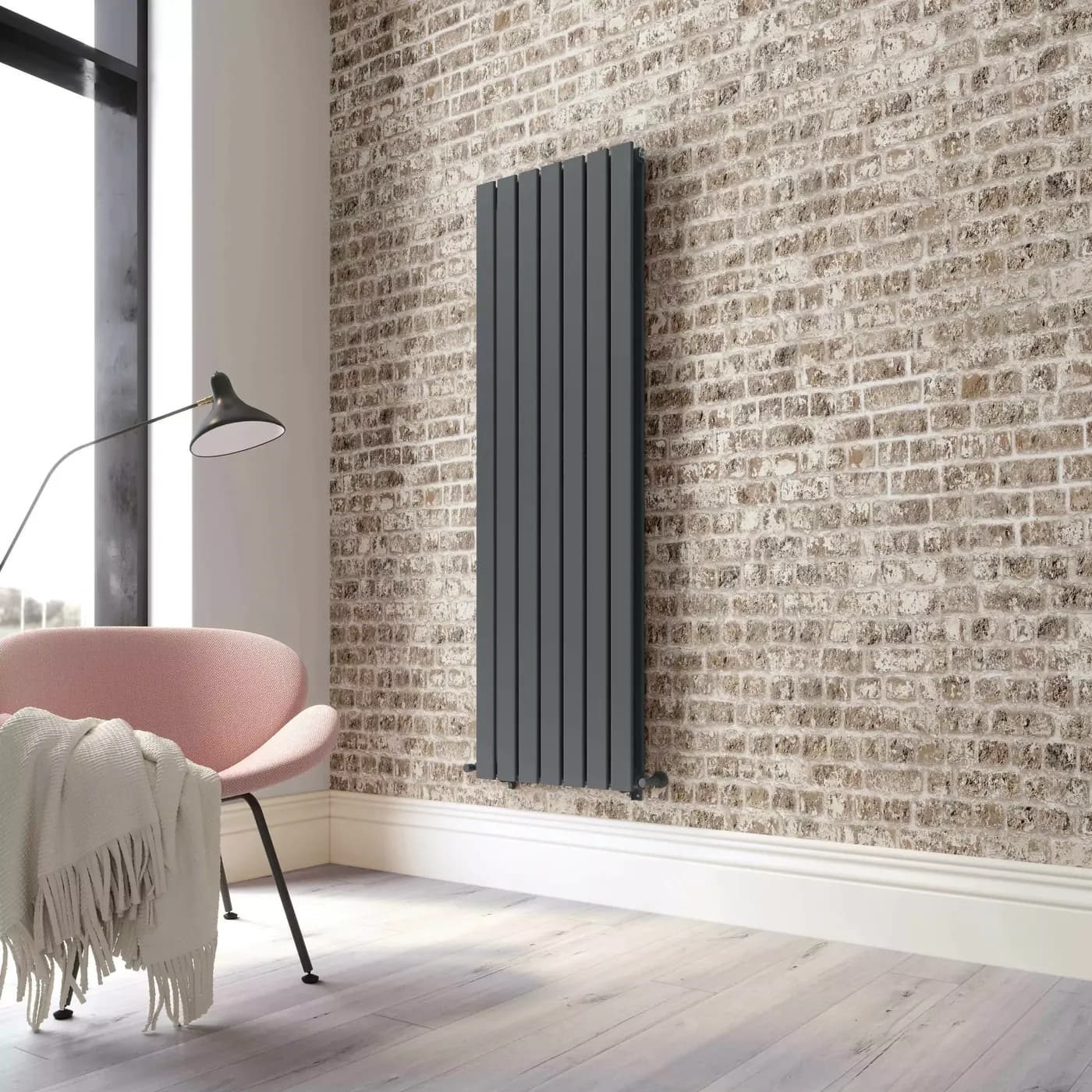 Anthracite vertical panel radiator on an exposed brick wall