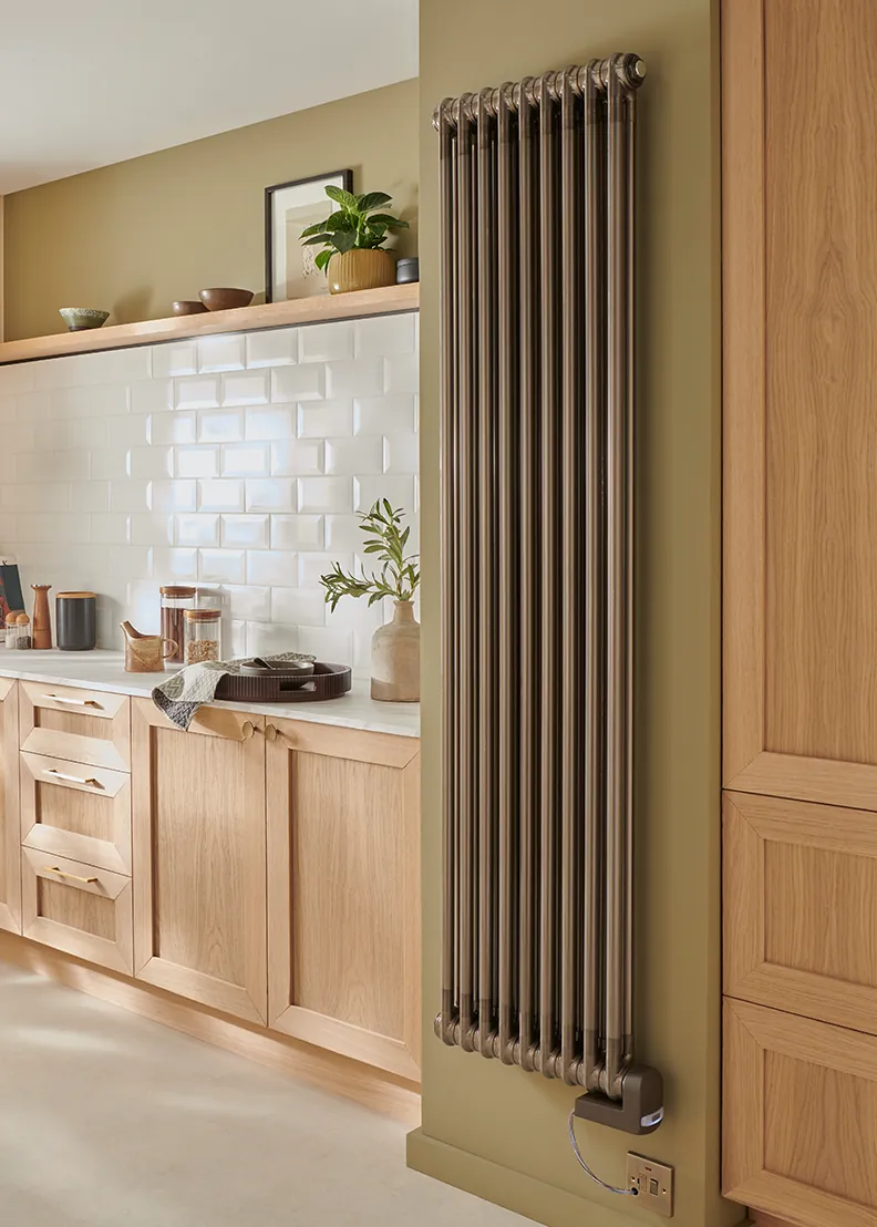 Tall bronze column radiator in a kitchen