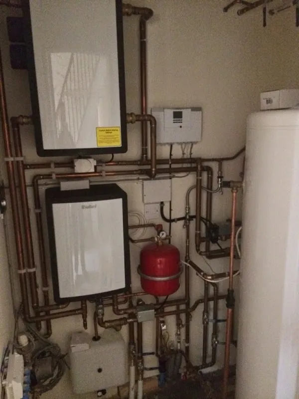 Vaillant boiler and controls in a cupboard with copper pipework